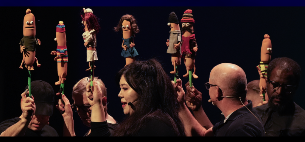 The cast with the hot dog puppets. Photo from the Puppet Up! site.